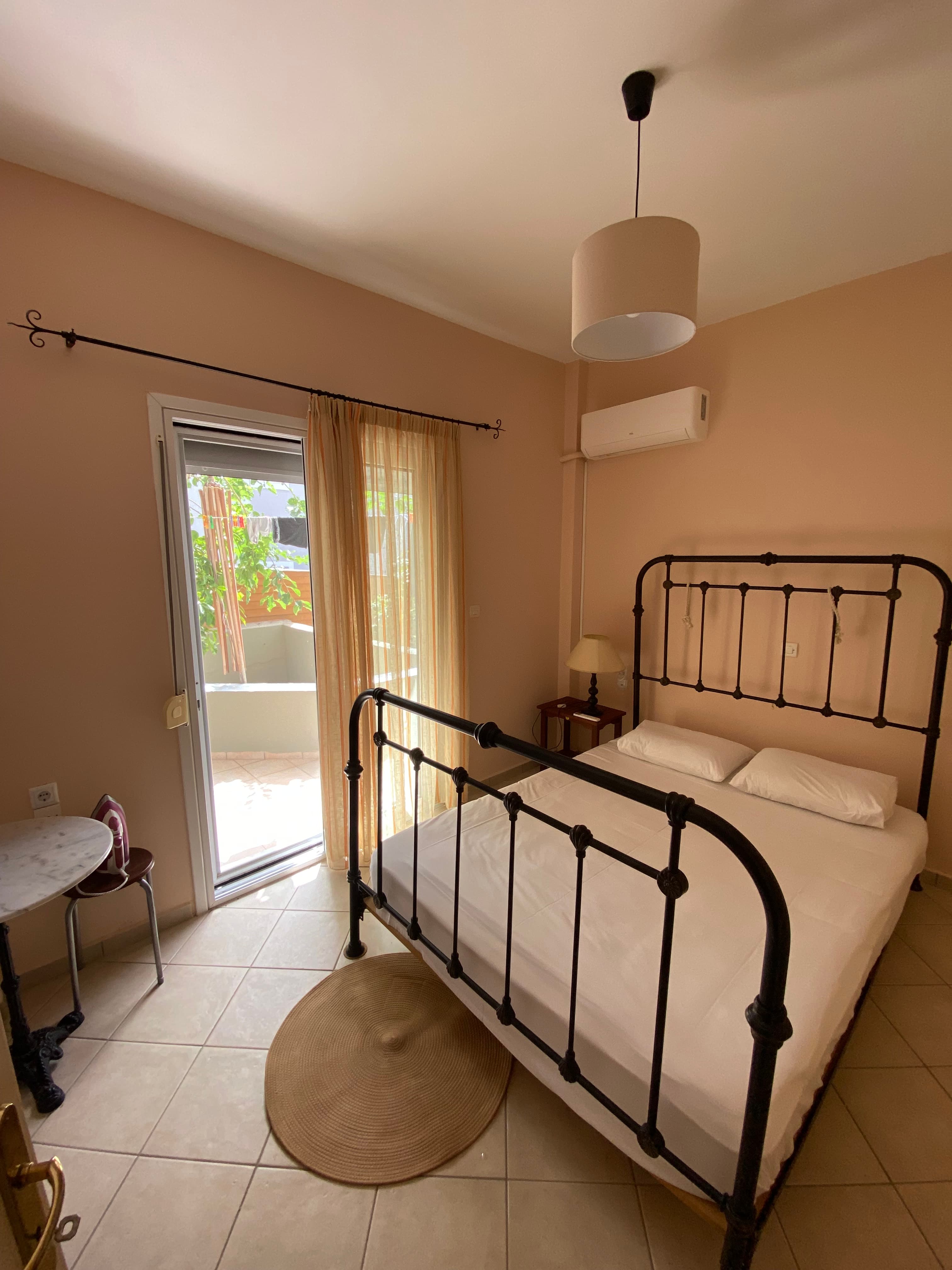 Bedroom with Metal Bed and Balcony Door